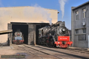 Freshly overhauled JS.6244 simmered in the sun outside the shed at Bajiaotai on 9 November. Spare loco JS.8116 was cold inside the shed. 