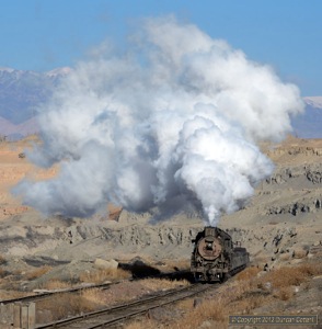 JS.8225 almost blotted out the Tianshan as it worked a loaded train out of the pit on 22 November.